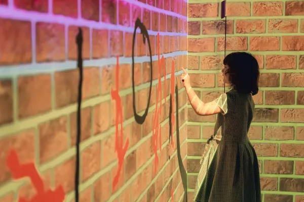 A child drawing using an interactive room.